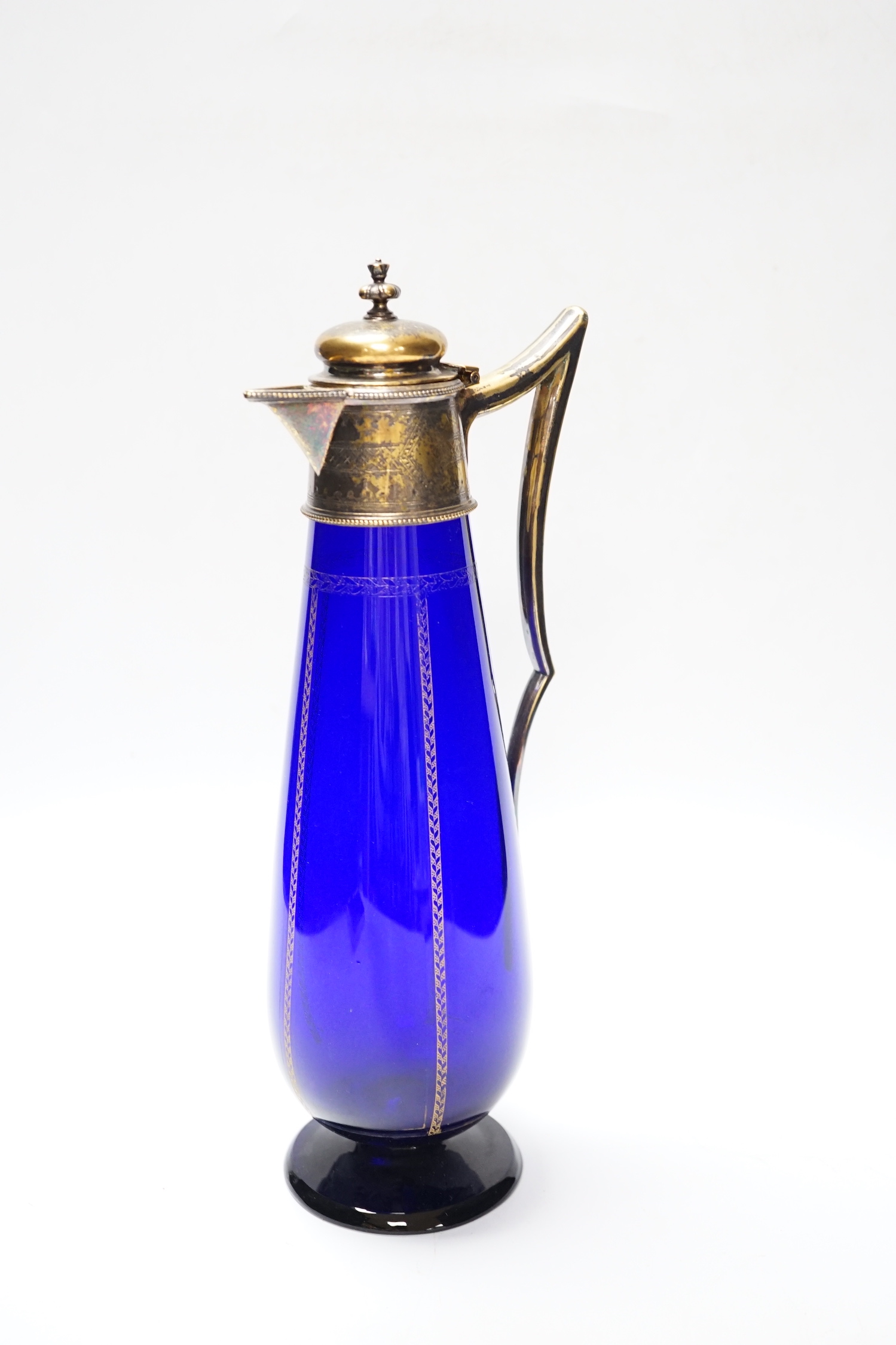 A 19th century Bristol blue cornucopia trumpet with metal hand mount with gilt decoration and a gilt decorated and mounted Bristol blue claret jug, jug 31.5cm high